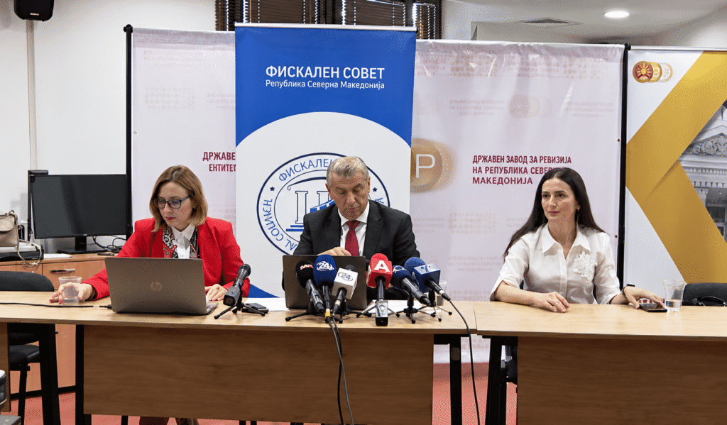 Press conference with microphones and laptops