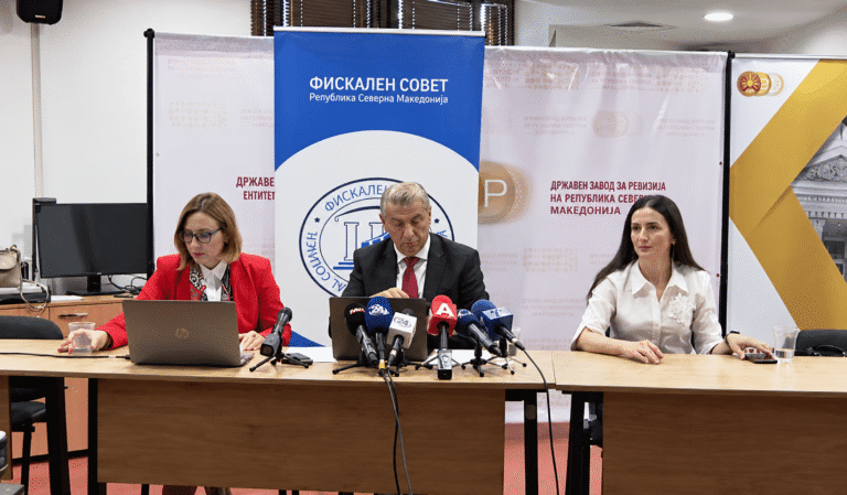 Press conference with microphones and laptops